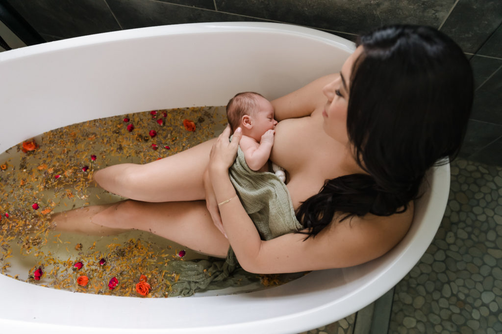 Mother nursing baby in studio bathtub, sitz bath and postpartum bath sessions in Boise, Idaho