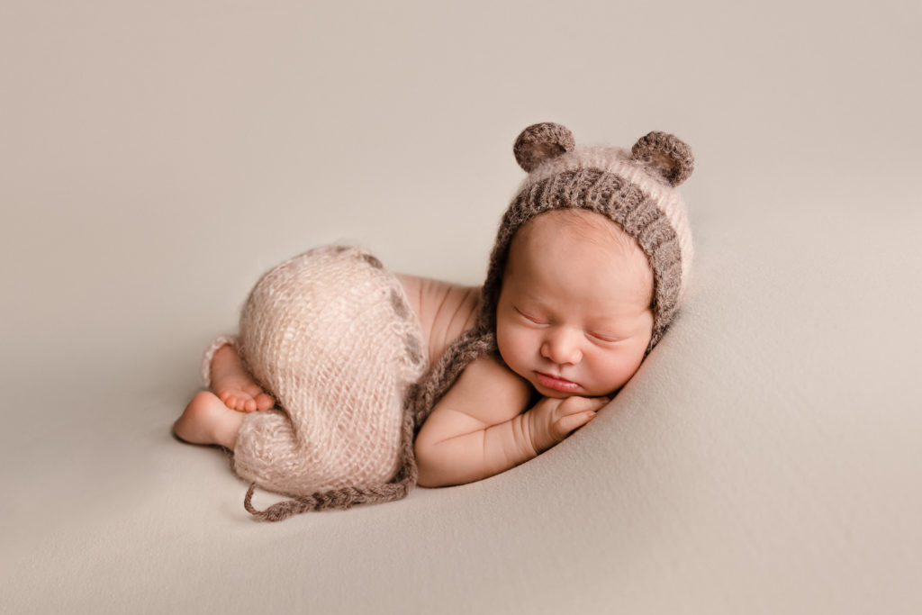 Baby boy in light brown bear hat