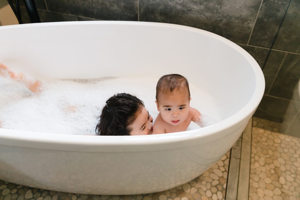 Siblings playing in bubble bath