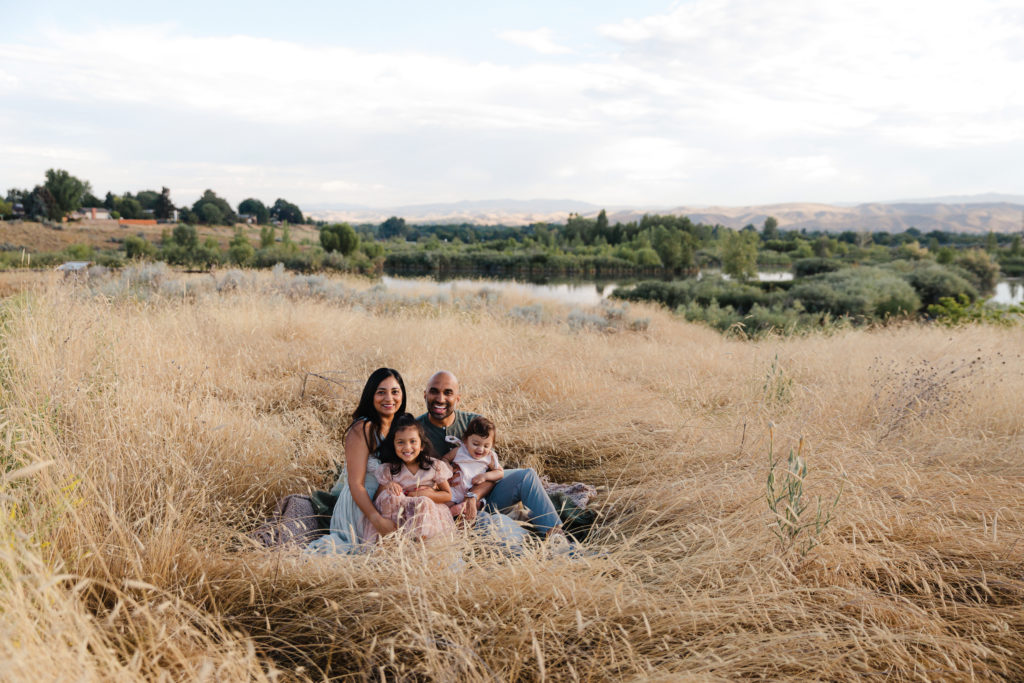 Family photos aren't just for fall, family seated in Boise field in July