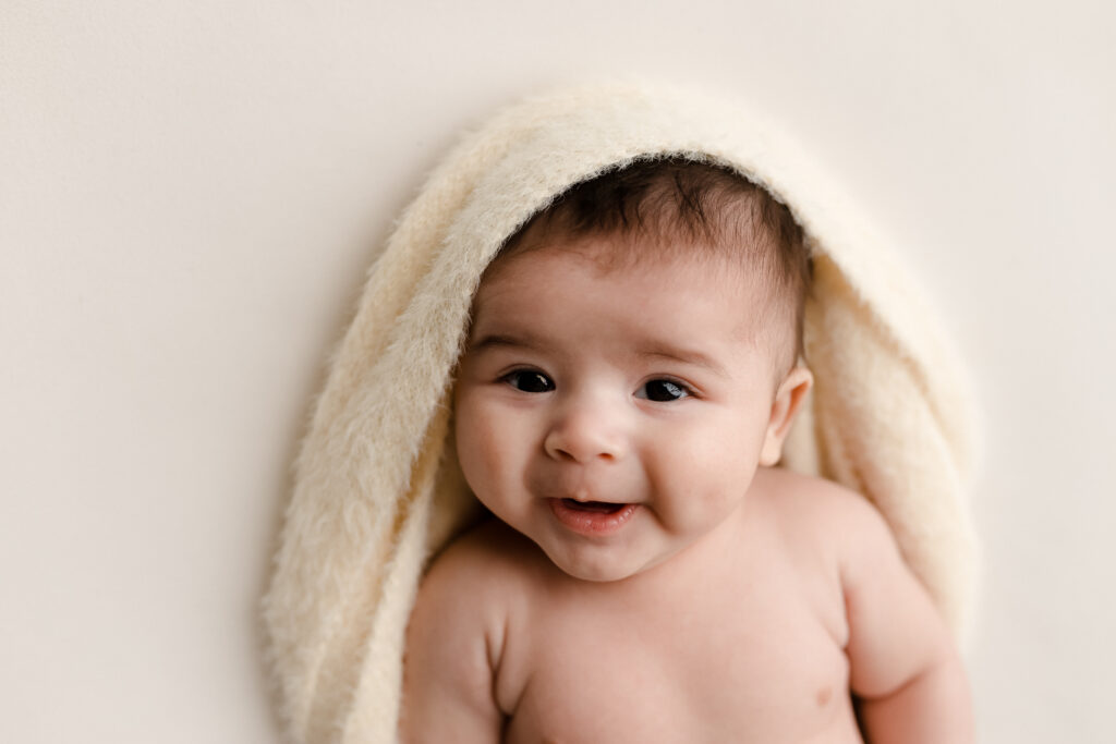 Baby with a towel over his head