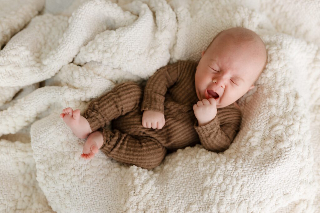 Sleepy baby yawning during photoshoot at Boise Idaho photography studio