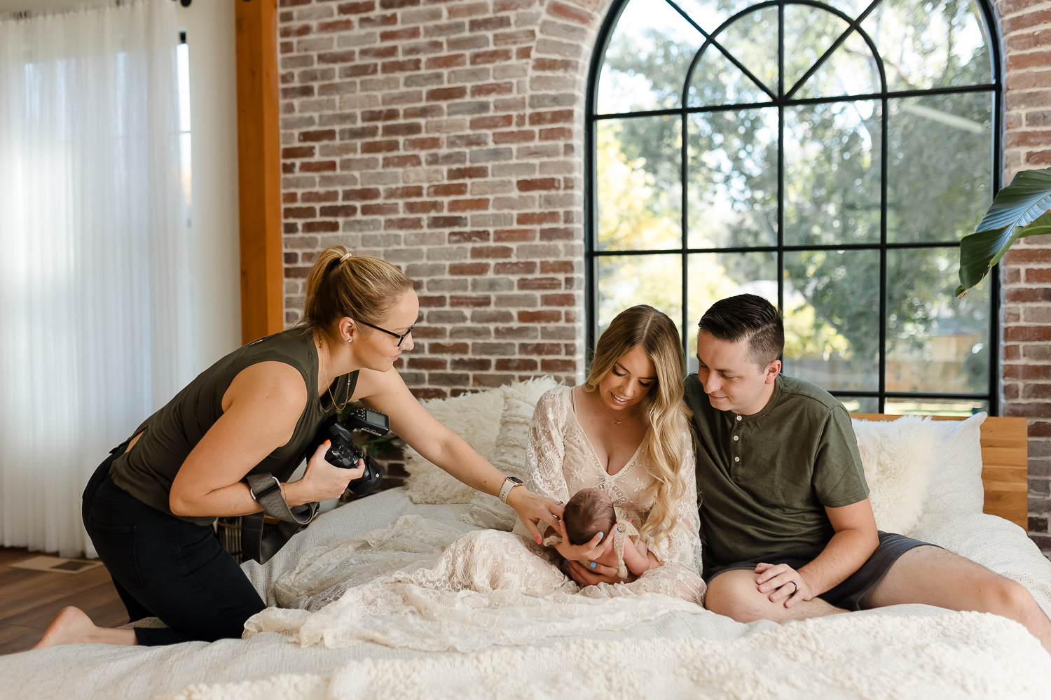 Newborn photography educator, Paige McLeod captures precious family moments with a newborn baby in a the Glean and Co Studio setting with a brick wall and arched window.