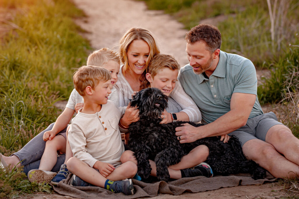 Family portrait with beloved dog, highlighting the importance of including pets in family photos