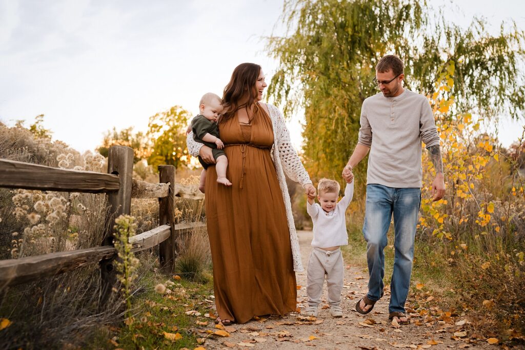 Family of four walking together in coordinated fall outfits