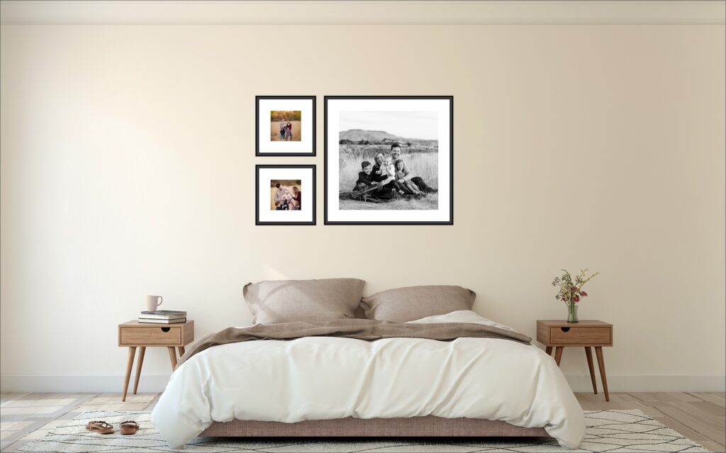 an example of a creative photo display of family photos where one photo is in black and white and much larger next to two smaller framed family images in color. 