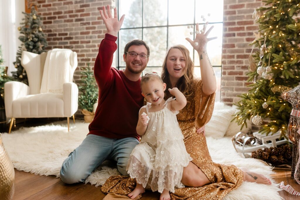 a family of three in boise's Glean and Co photography studio celebrates the holiday season with a fun activity for kids and young families