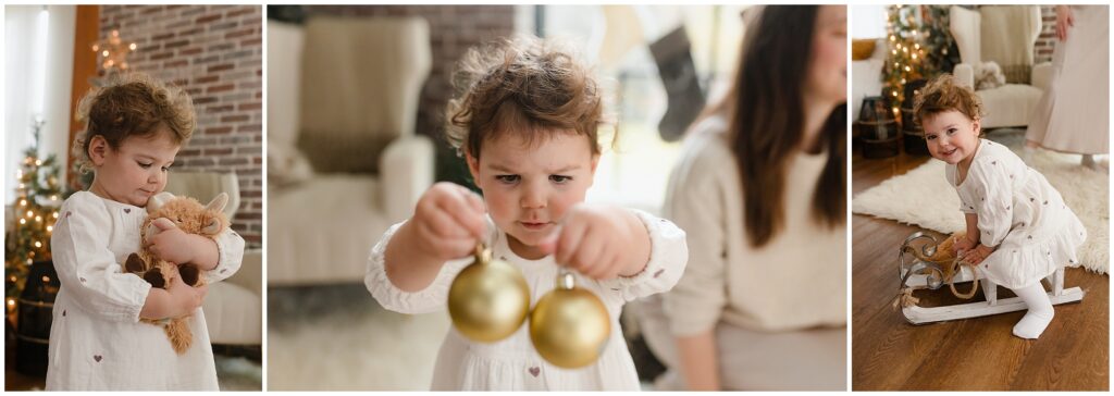 a toddler girl celebrates the holiday season by playing with ornaments and a winter sleigh in boise idaho