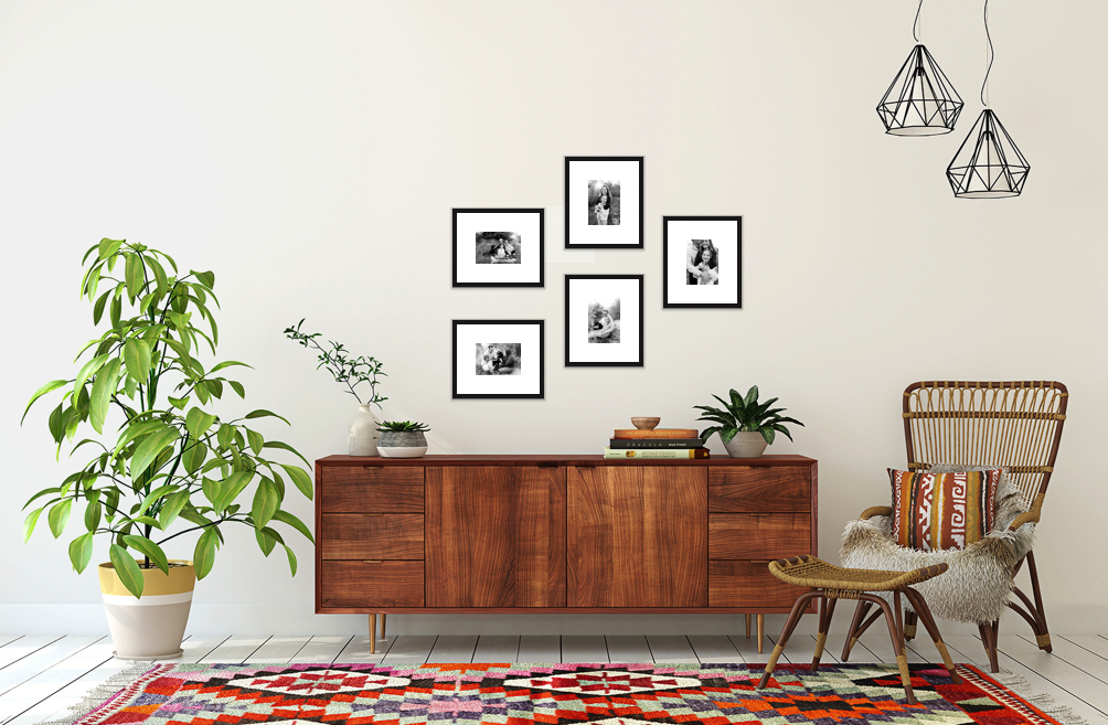 a creative wall disply for family photos showcased in a non-grid pattern with all black and white photos