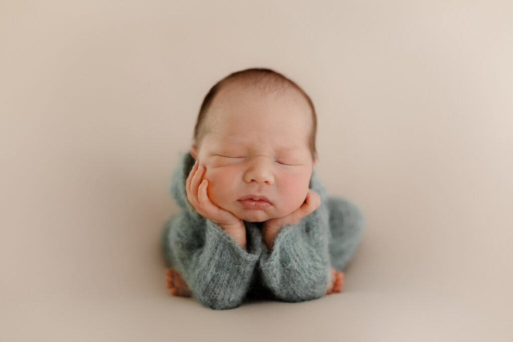 a baby shown in the froggy pose - a position that is absolutely essential to be composited in Photoshop for safety purposes. 