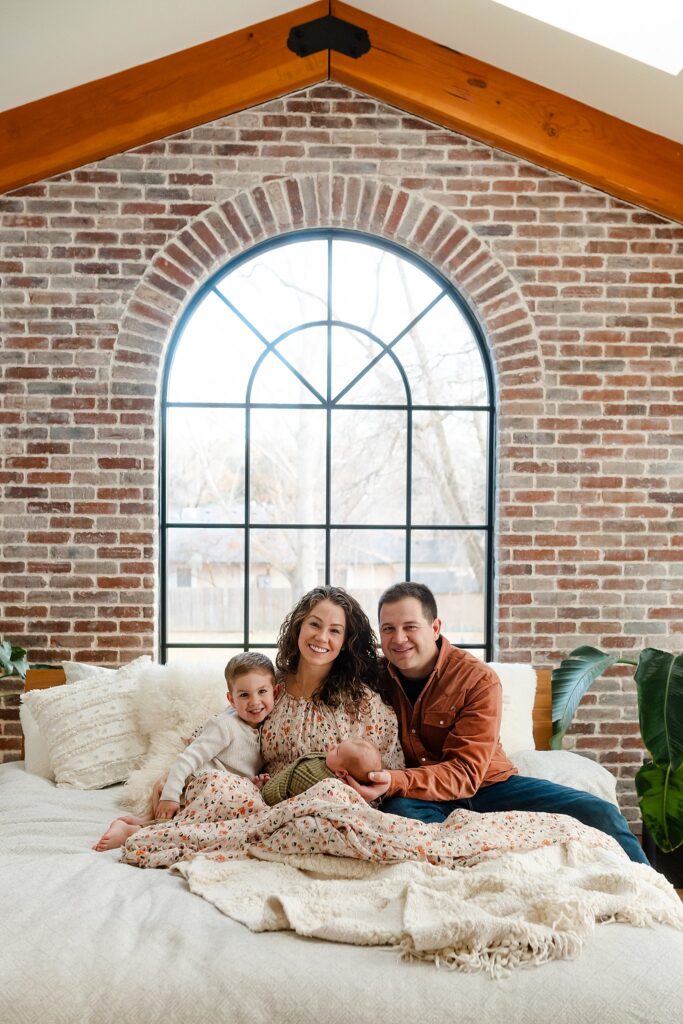 new family of 4 smiling in Boise Idaho's Glean & Co Newborn Photography studio