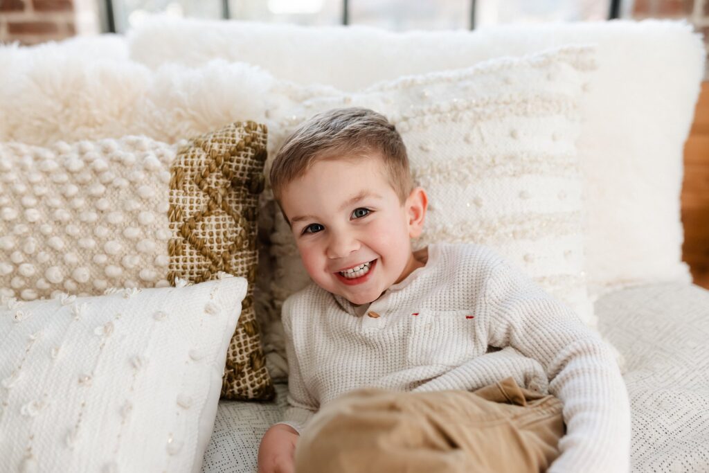 the older brother getting his solo shot durings his little brothers baby photos.