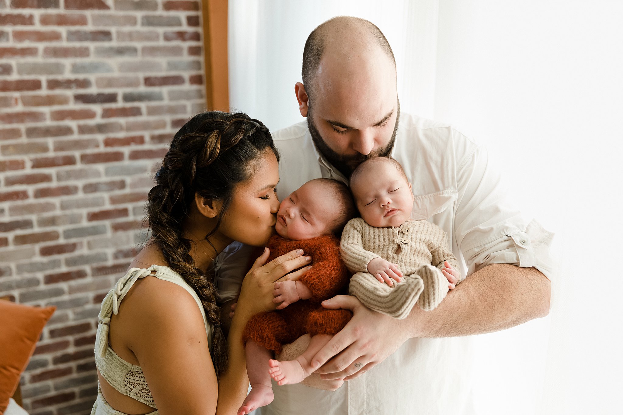 a couple with newborn twin boise during their photoshoot in the Glean and Co studio