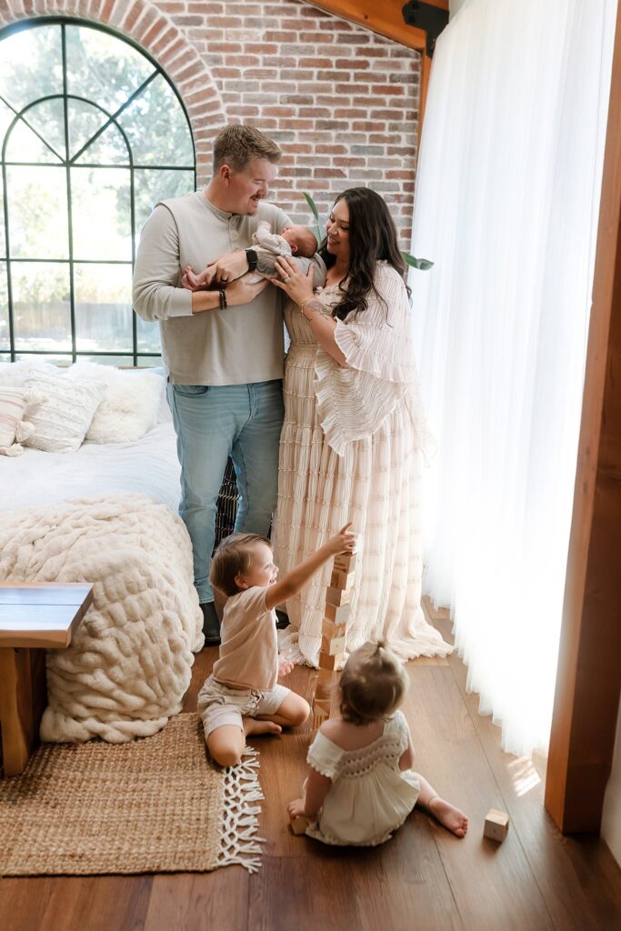 Treasure Valley family newborn session showing parents with children after preparing child for new baby arrival