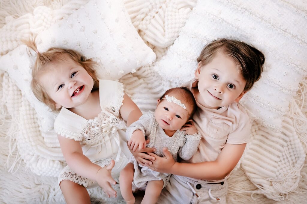 Professional newborn photography in Boise showing how to prepare child for new baby with sibling photos