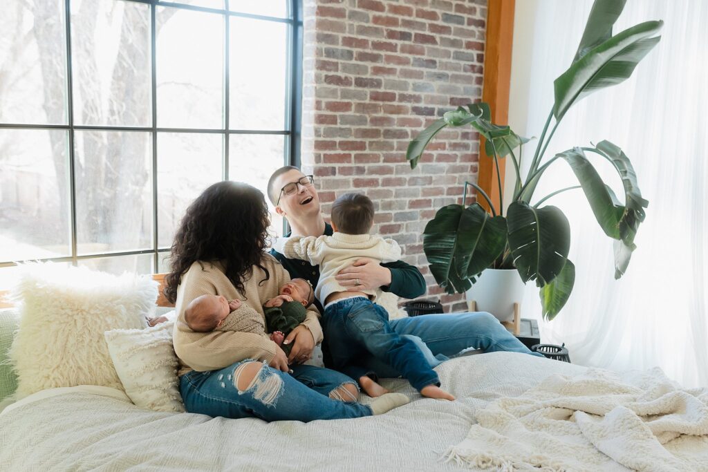 a family of 5 having their newborn twins photography session in the Glean and Co studio in Boise Idaho