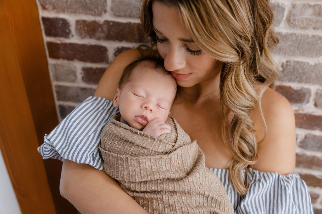 a mom with professional hair and makeup at her relaxed luxury newborn session with Glean and Co Photography in Boise Idaho