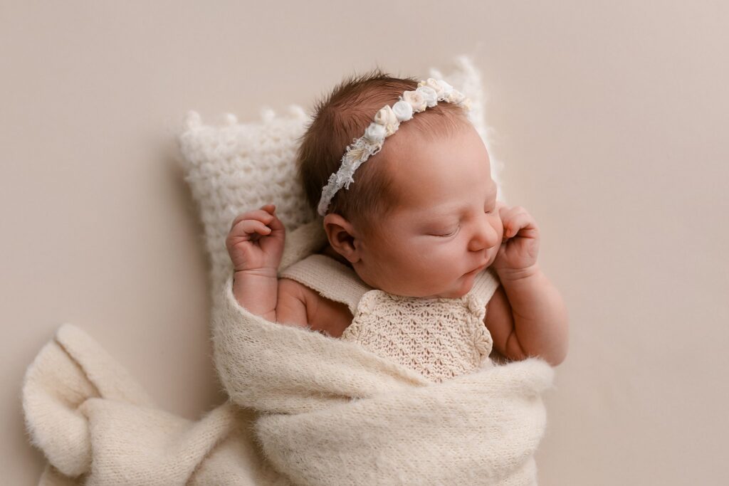 Sweet baby girl wrapped in soft white blankets captured by Boise's best newborn photographer at Glean & Co studio