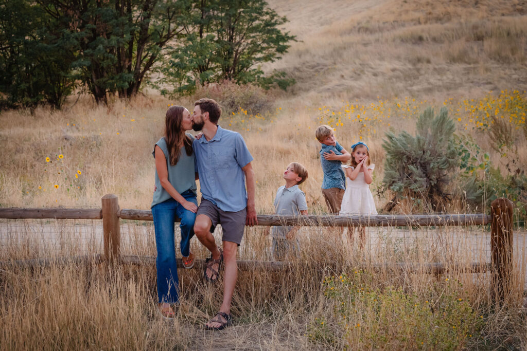 Family of five posing among wild sunflowers during sunflower family photos Boise Idaho session with Boise's best family photographer, Glean and Co