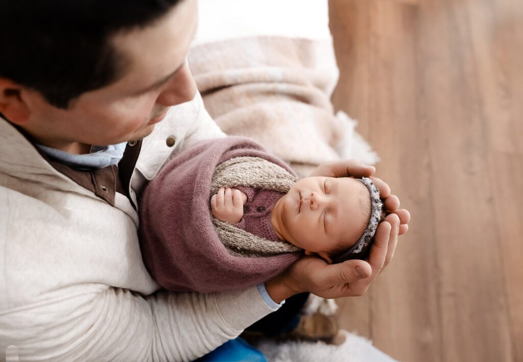 newborn photography near me in Boise ranges from lifestyle newborn photographs like this example of a baby girl and new dad in the Glean & Co Studio to fully posed baby only shots