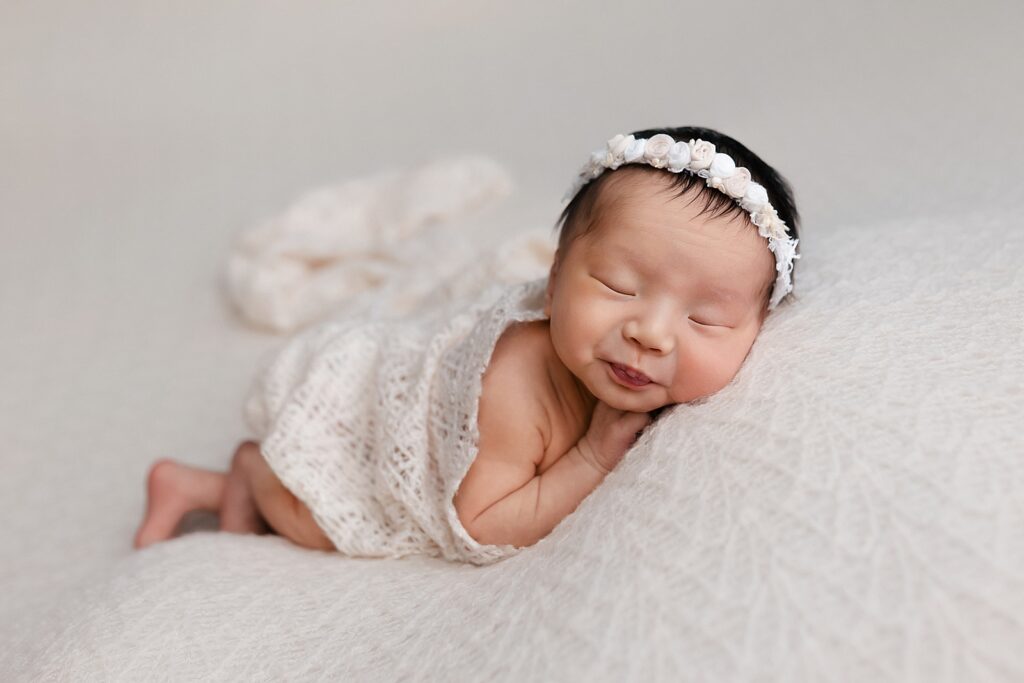 newborn photography boise create images like this little girl sleeping soundly on a white background