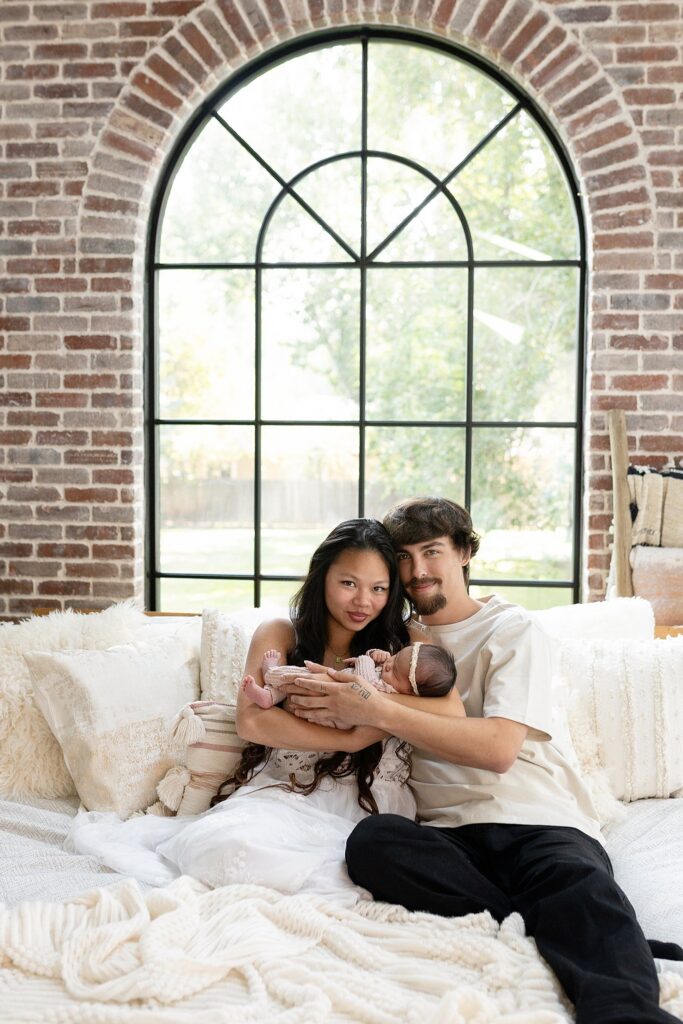 a mom and dad snuggling their newborn daughter during stress free newborn portraits with Glean & Co Photography